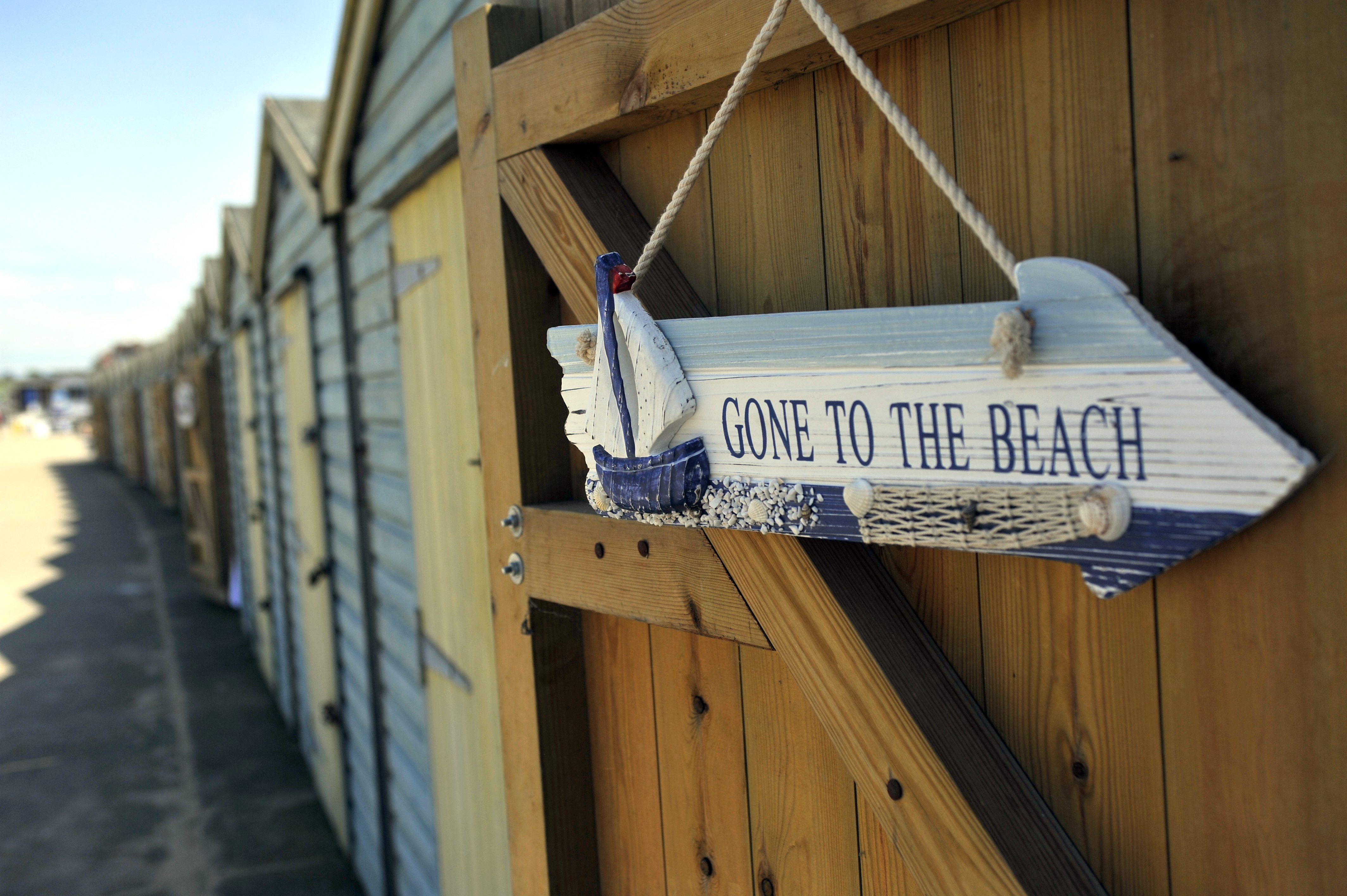 Row of beach huts with 'gone to beach' sign - credit Thanet Tourism.JPG